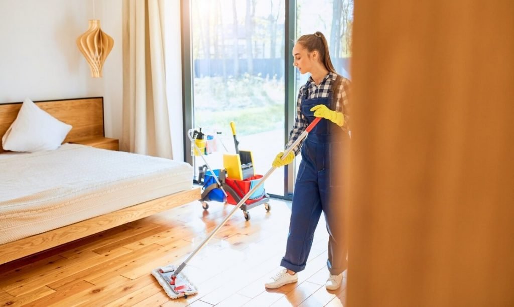 Woman Cleaning a Bedroom