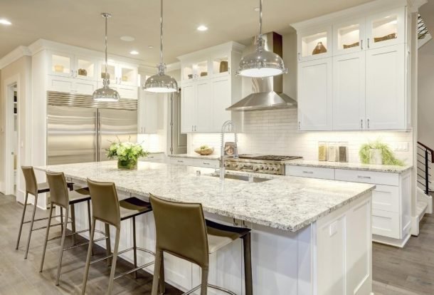 Kitchen with marble kitchen countertop in the center Orchid Cleaning Services