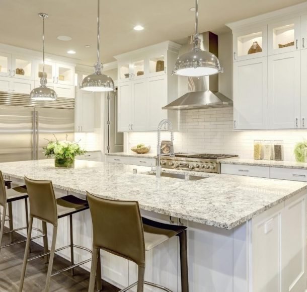 Kitchen with marble kitchen countertop in the center Orchid Cleaning Services