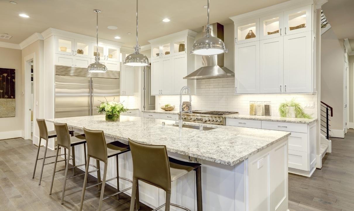 Kitchen with marble kitchen countertop in the center Orchid Cleaning Services