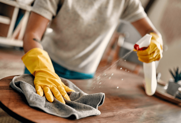 Man cleaning with yellow gloves a kitchen surface