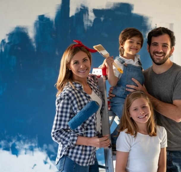 Cleaning | Family painting a wall of color blue