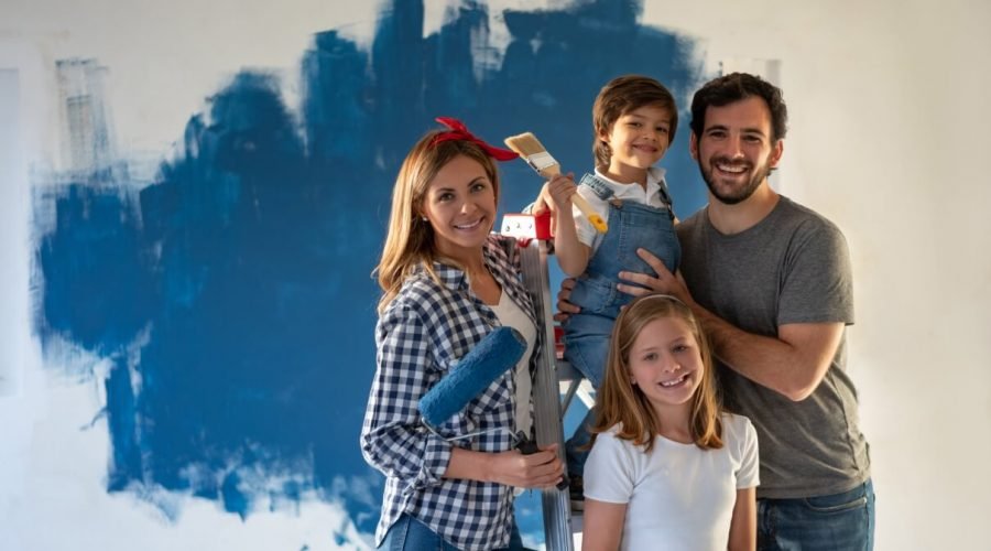 Cleaning | Family painting a wall of color blue